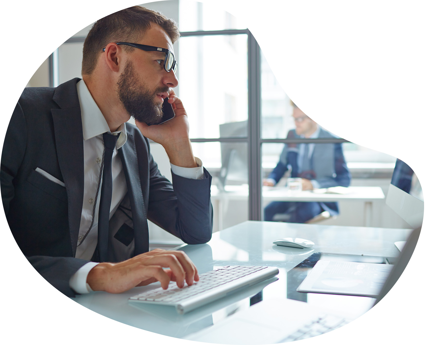 man in modern office on phone to customer